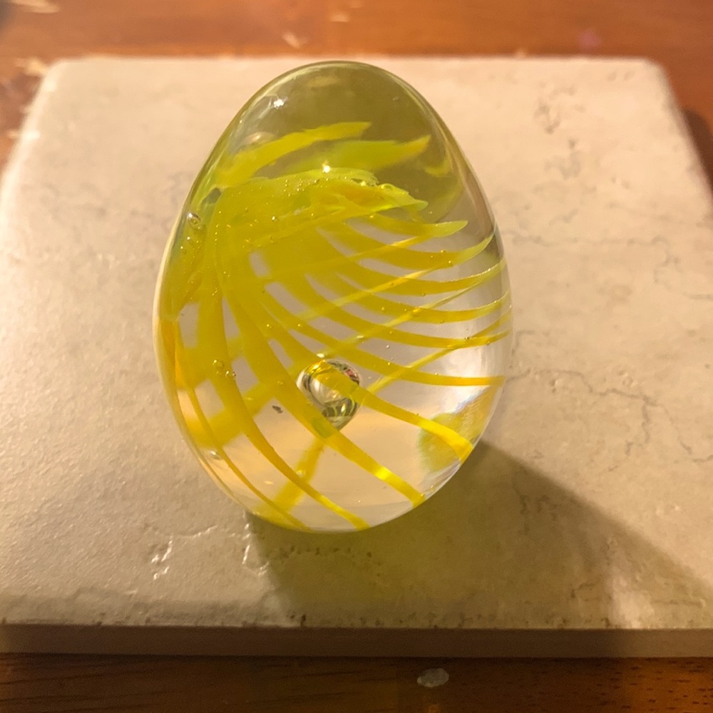 Yellow striped, egg shaped paperweight